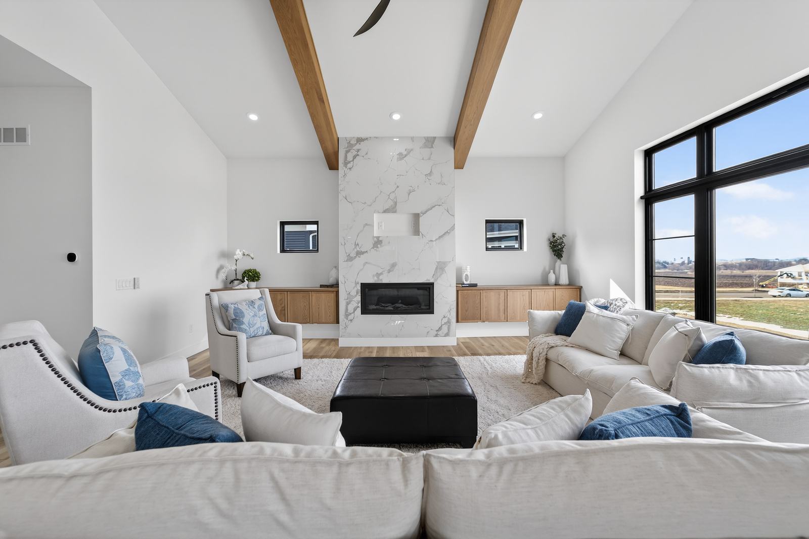 Great room with vaulted ceiling, wood beams and marble fireplace