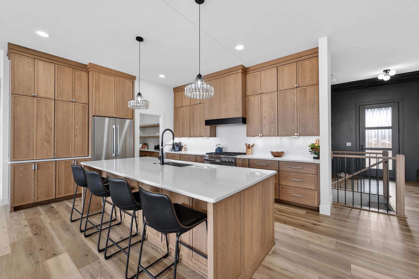 Kitchen with oak cabinets and large island with seating