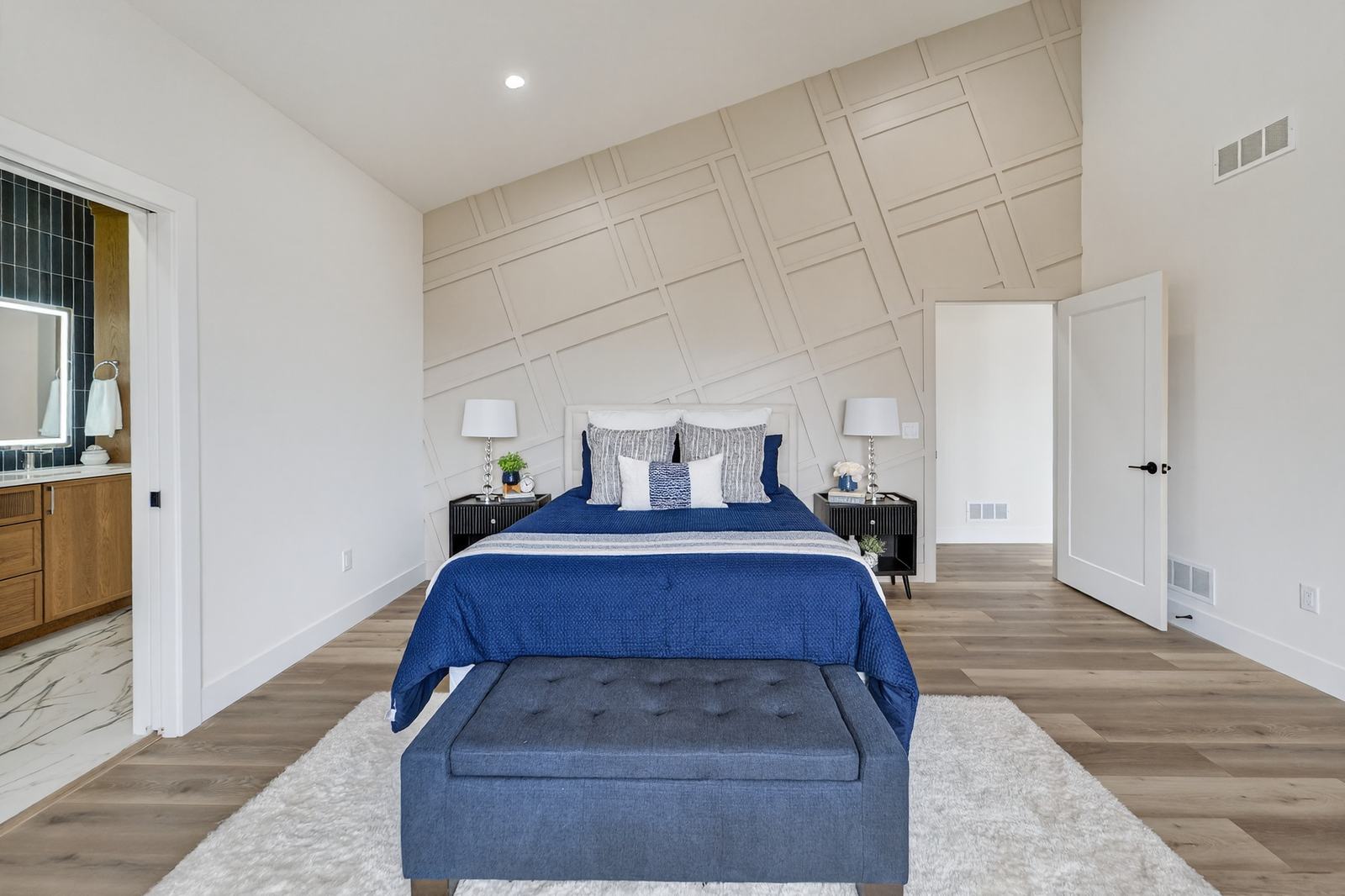 Primary bedroom with paneled accent wall